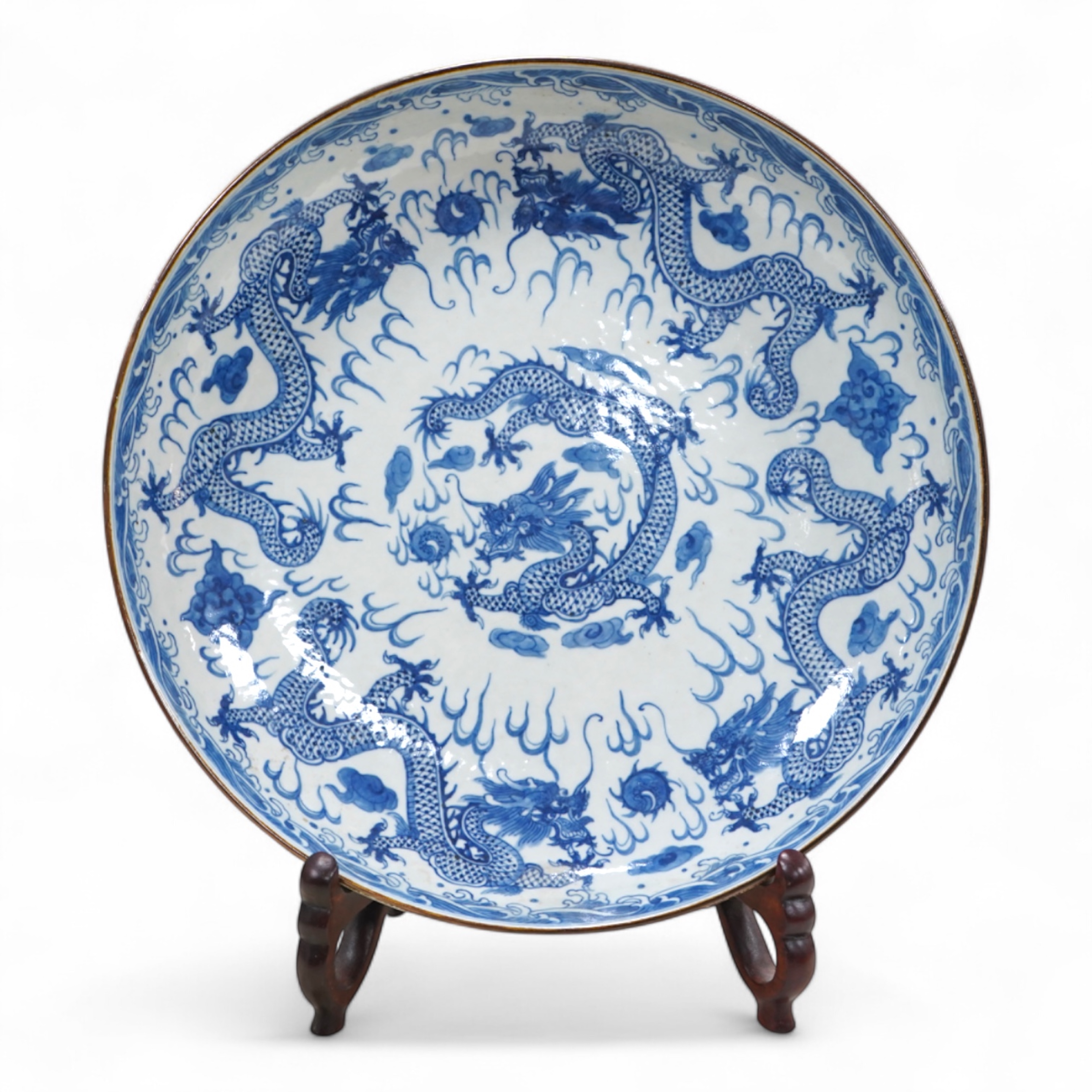 A Chinese black and white 'dragon' dish Xuande mark, 20th century, 27cm diameter